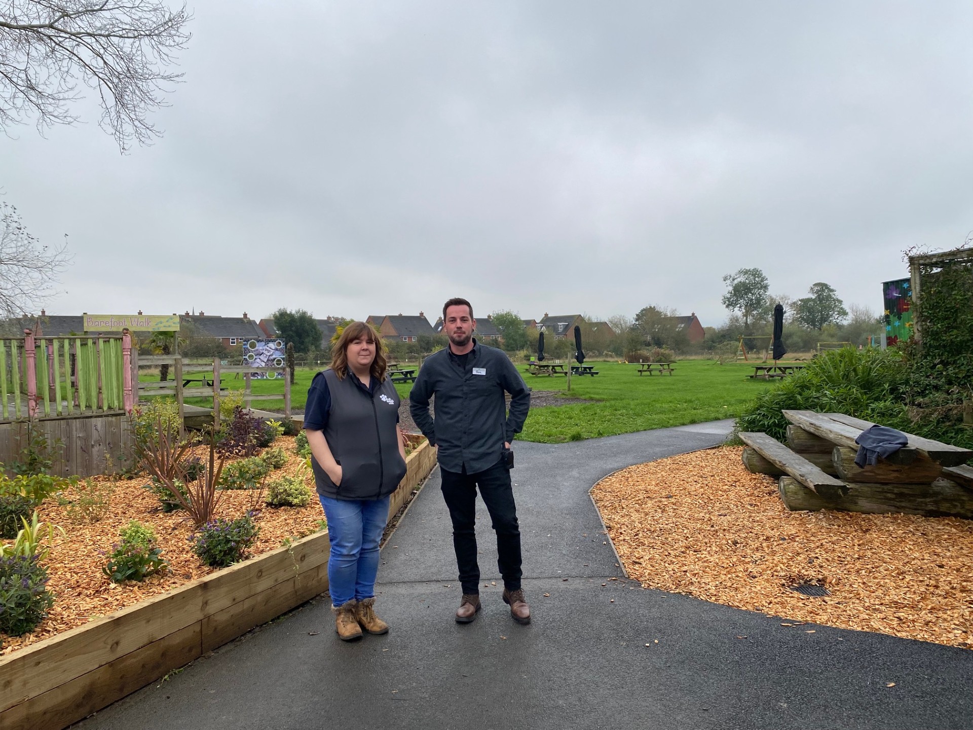 Two people standing at a park